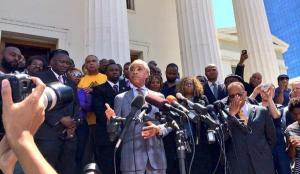 Al Sharpton speaks to a crowd at the St. Louis downtown courthouse